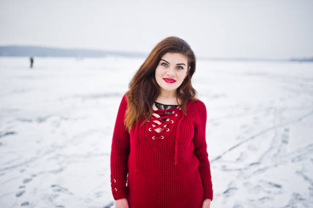 istock Brunette plus size model at red against frozen lake on winter day. 919313668