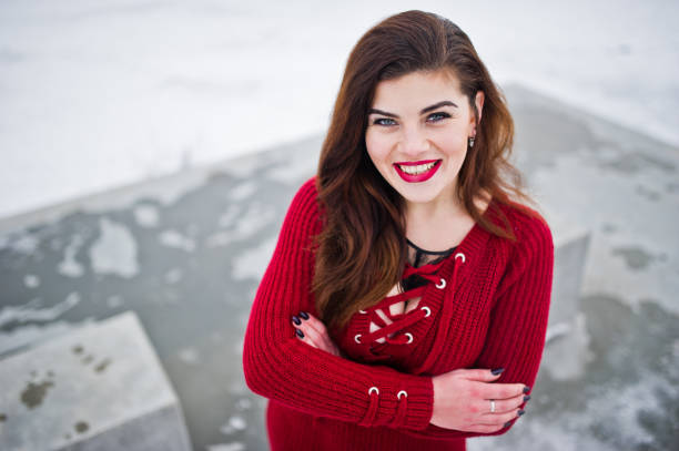 istock Brunette plus size model at red against frozen lake on winter day. 919317562
