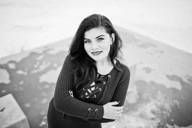 istock Brunette plus size model at red against frozen lake on winter day. 919317794