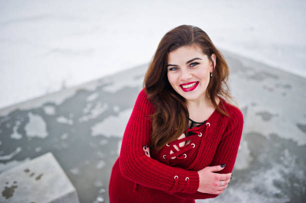 istock Brunette plus size model at red against frozen lake on winter day. 919317802