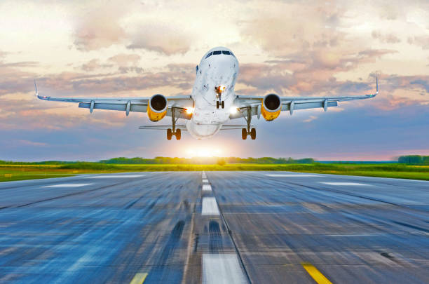 istock Passenger airplane landing at sunset on a runway. 919323124