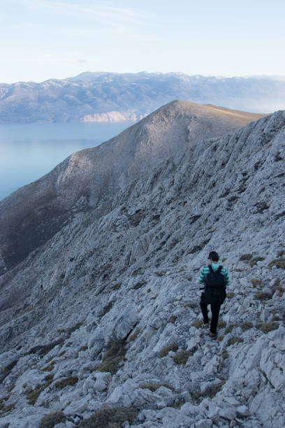 istock Man with backpack hiking in rocky mountain 919323414