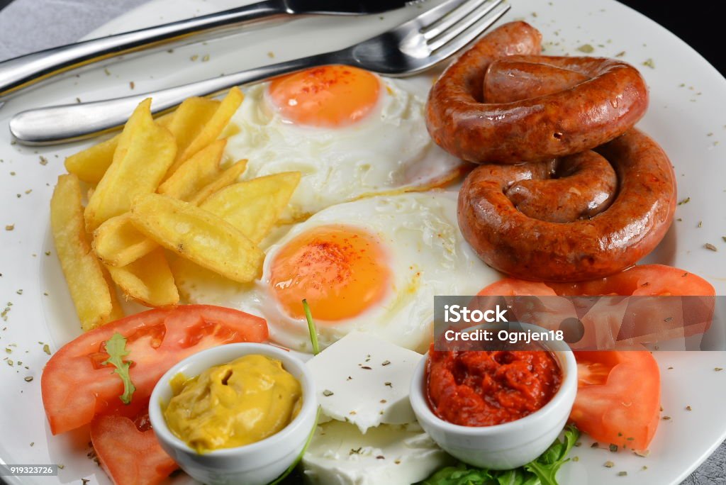 Breakfast with Eggs, Sausage and French Fries Breakfast, Egg, Sausage, Bacon, Fries 2018 Stock Photo