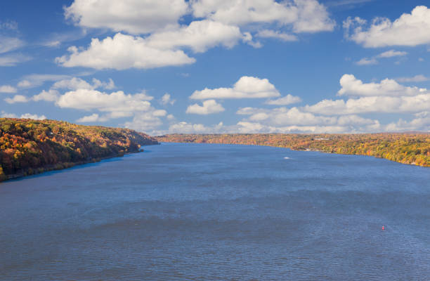 istock Hudson River with Trees in Autumn Colors and Blue Sky with Clouds as seen from Walkway over the Hudson, Poughkeepsie, Hudson Valley, New York. 919338636