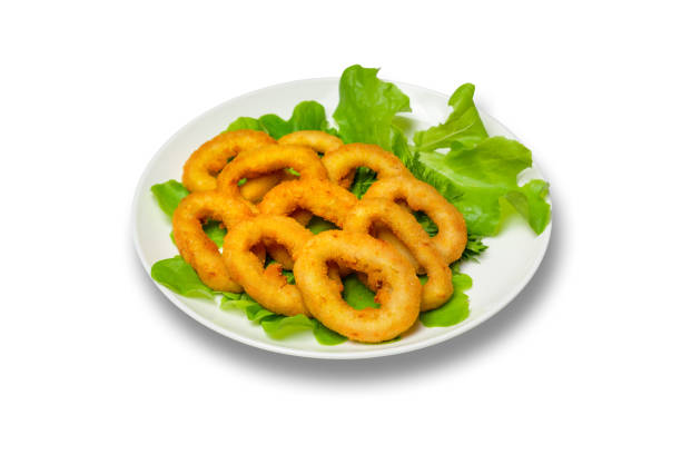 Onion rings with lettuce on a plate on a white background