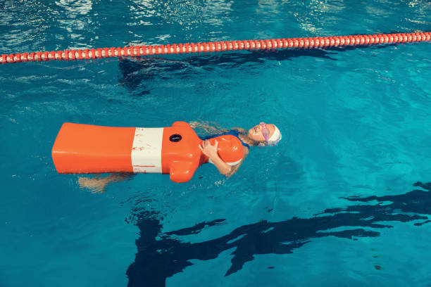 School Girl in a Pool Rescue Training Dummy