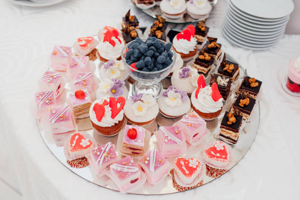 istock luxury wedding catering, table with modern desserts, cupcakes, sweets with fruits. delicious candy bar at expensive wedding reception. 919358972