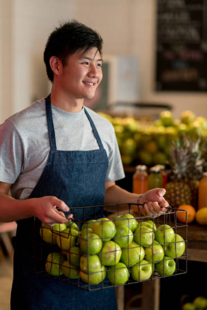istock Employee at a juice bar organizing the fruit baskets looking very happy 919359134