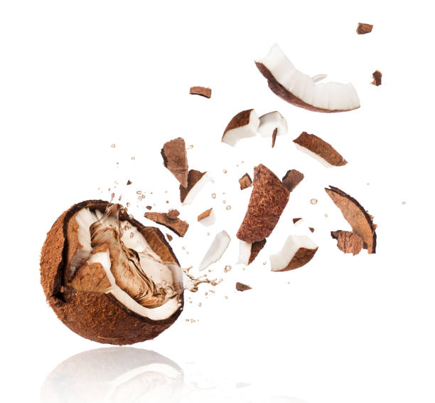istock Broken coconut with splashes of juice close-up, isolated on white background 919387594