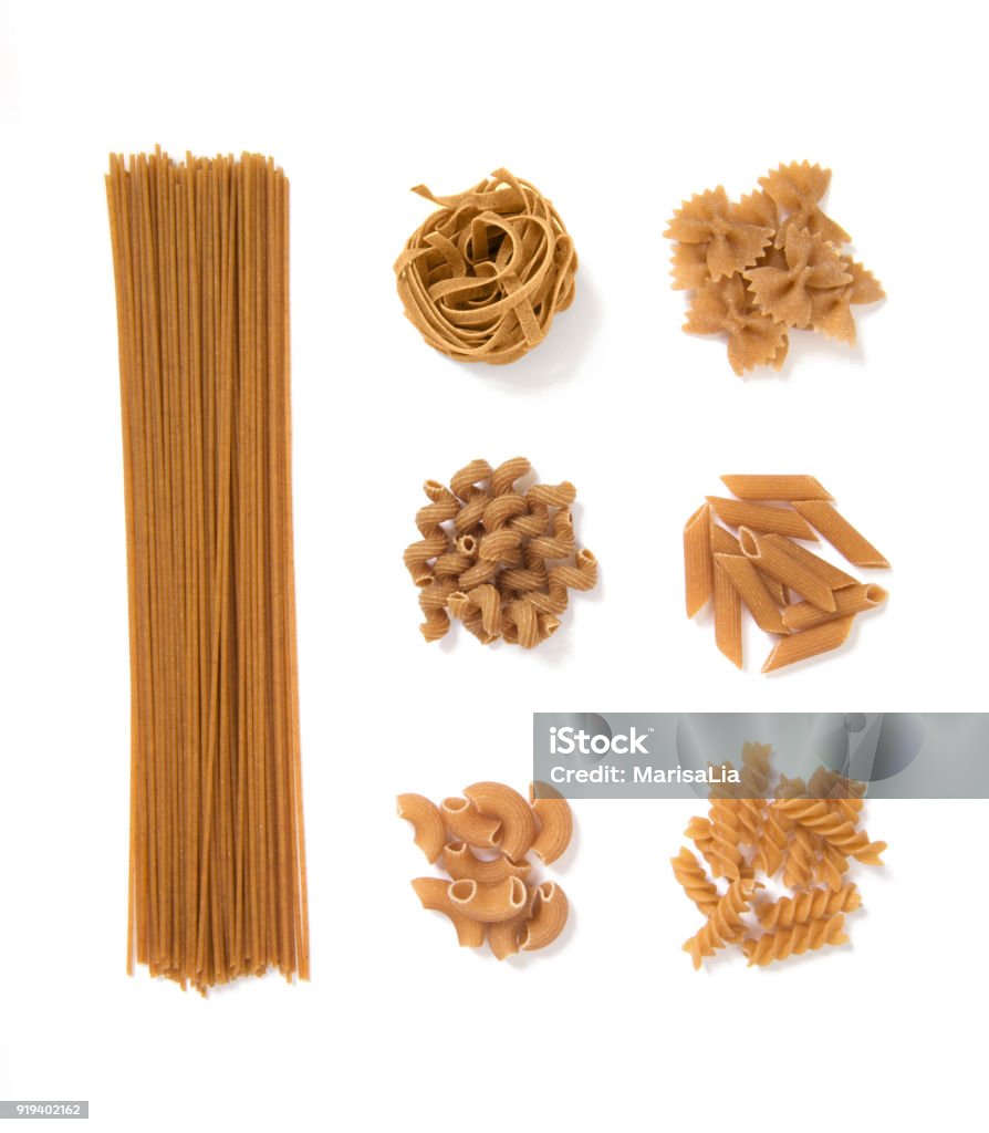 selection of whole grain pasta, isolated on white background: spaghetti, tagliatelle, farfalle, cellentani, penne, fussili Pasta Stock Photo