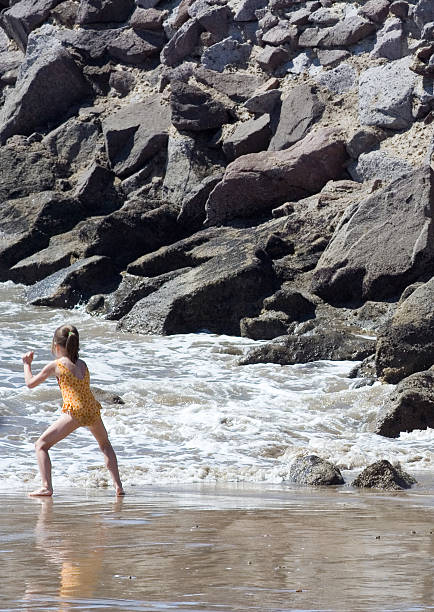 istock Girl Playing Along Rocky Coastline 91941560