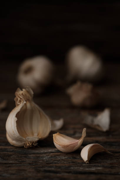 istock Still life of garlic bulb in dark black background 919418042