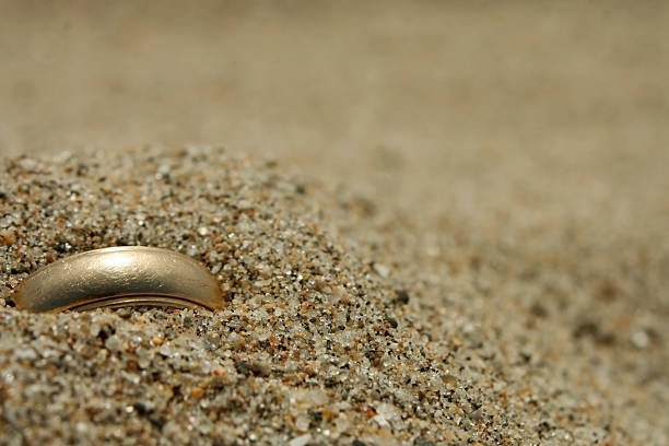 anillo de boda de oro perdido en la arena - lost beach fotografías e imágenes de stock