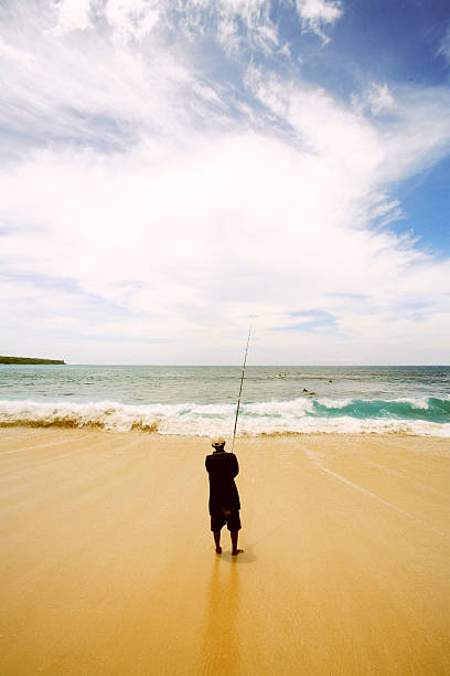istock Boy fishing on beach 91942395