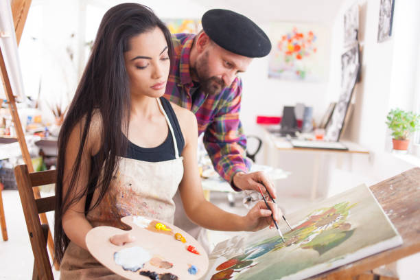 istock Fine art student working with teacher in atelier 919430604