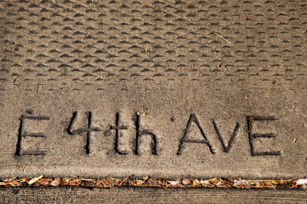 E 4th Ave stamped in a concrete sidewalk