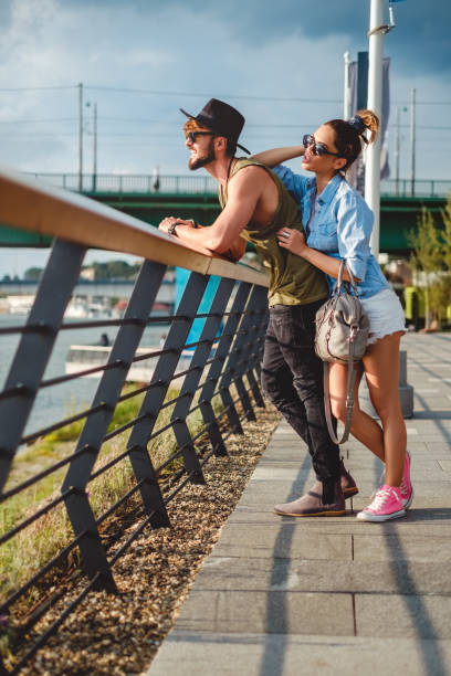 istock Couple watching sunset by the river 919444084