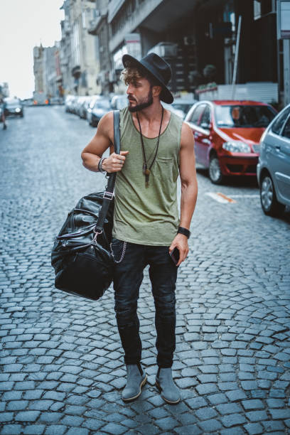 istock Hipster man standing on the street 919444104