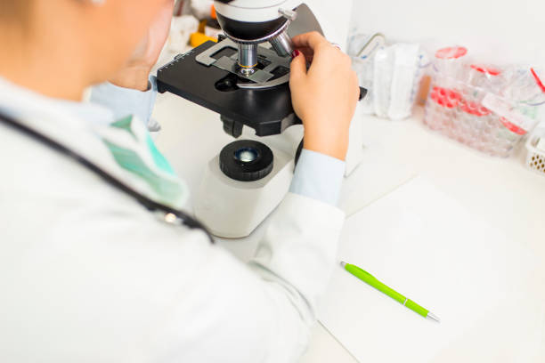 istock Young doctor or scientific researcher using microscope in a laboratory 919447496