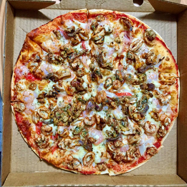 istock Pizza Time: take-away (take out) seafood pizza in a box 919449744