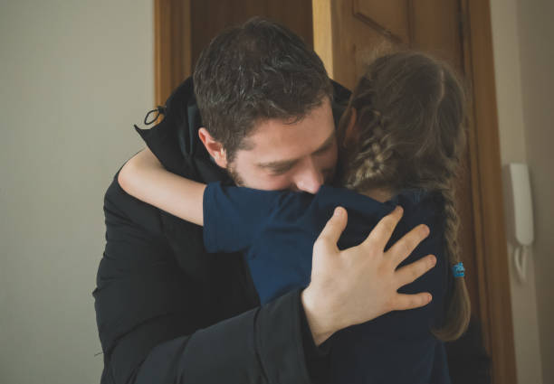 istock Father hugging her daughter after long trip. 919455582