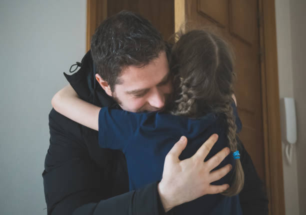 istock Father hugging her daughter after long trip. 919455600