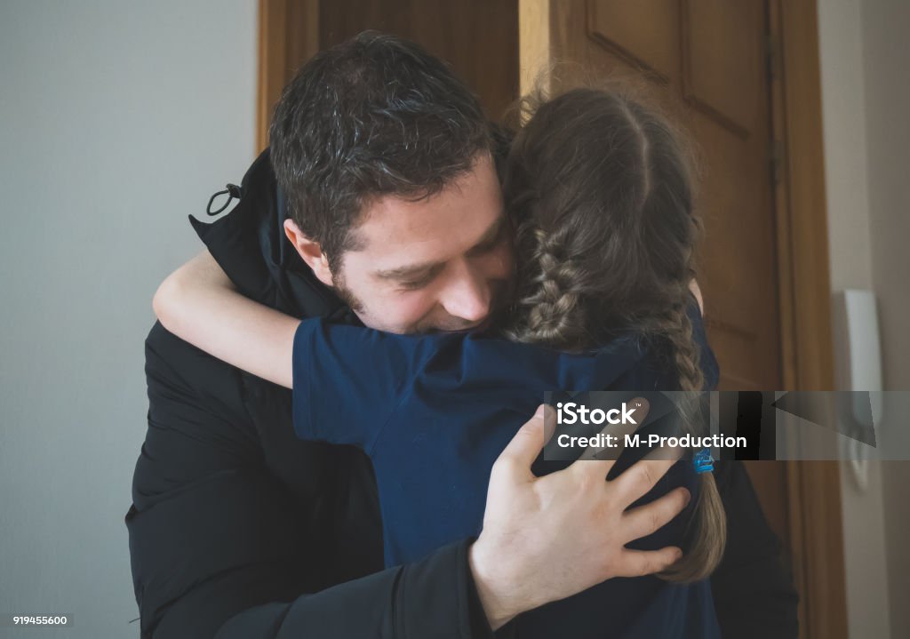 Father hugging her daughter after long trip. Father Stock Photo