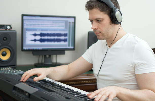 istock Handsome man recording song in music studio. 919458018