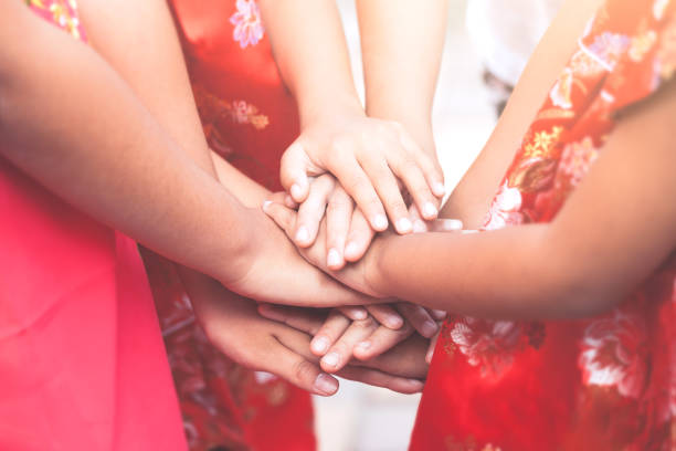 istock Children holding hands and playing together with unity and teamwork 919460916