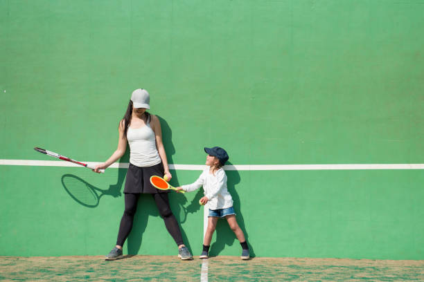 madre e figlia che praticano il tennis - tennis court love victory foto e immagini stock