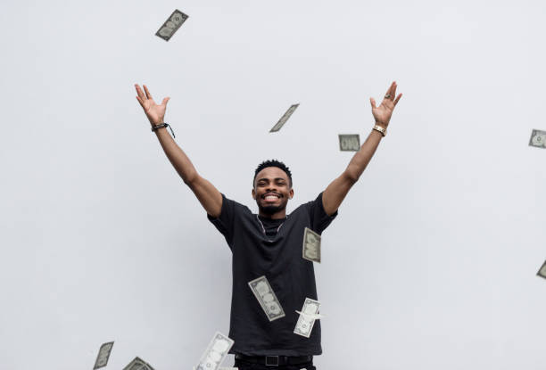 istock A wealthy African man throwing away his money 919476016