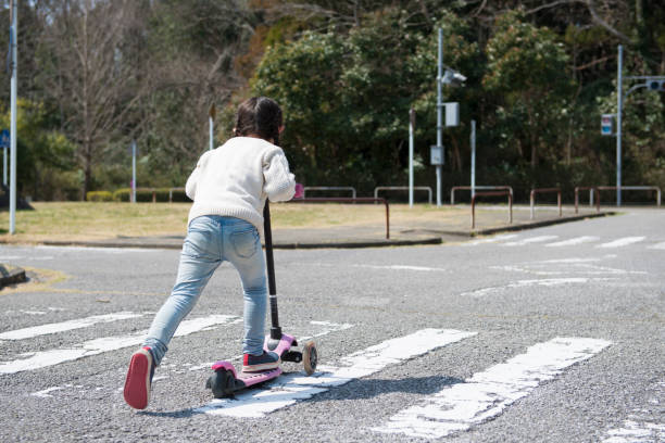 istock Little girl playing with kick skater 919476132