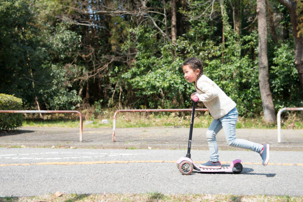 istock Little girl playing with kick skater 919476344