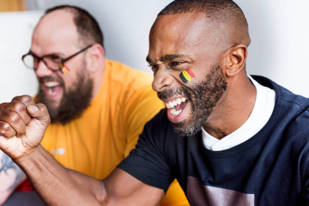Friends cheering world cup with painted flag