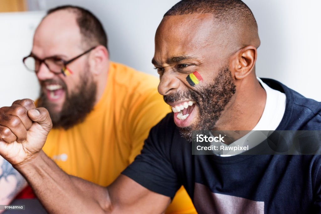 Friends cheering world cup with painted flag Soccer Stock Photo