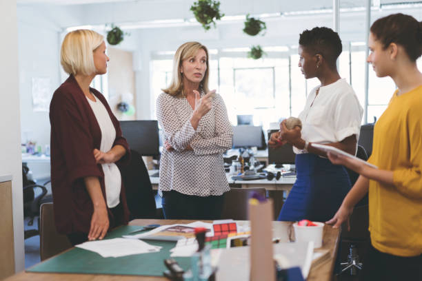istock Businesswoman discussing with colleagues at table 919499624