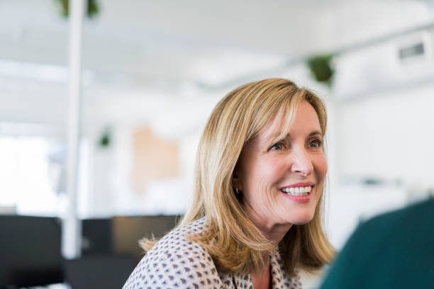 Smiling businesswoman looking away in office
