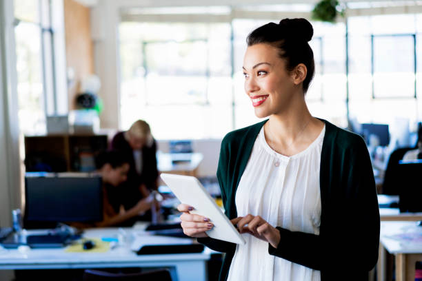 istock Smiling businesswoman with tablet PC in office 919501946