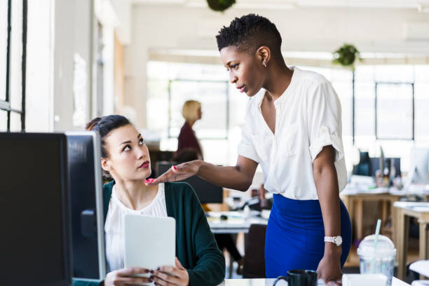istock Multi-ethnic businesswomen discussing at desk 919502286