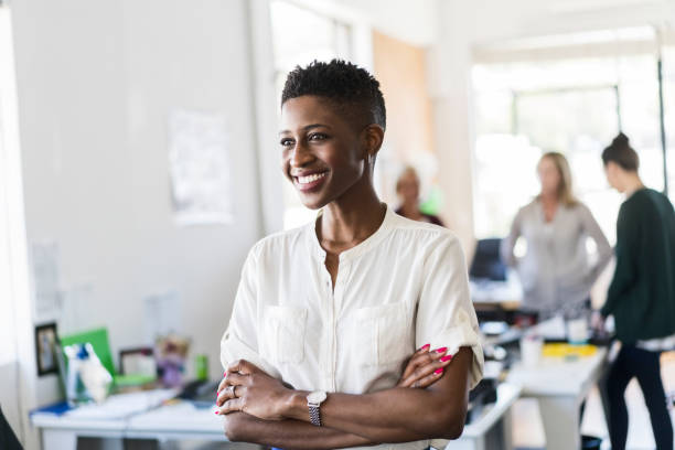 istock Smiling businesswoman looking away at office 919502294