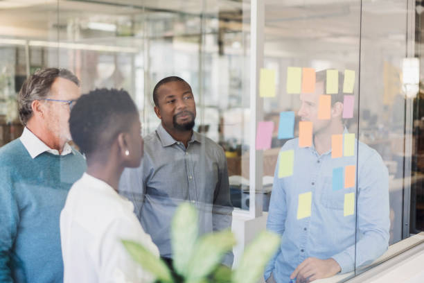 istock Business people discussing over adhesive notes 919504696