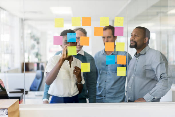 istock Businesswoman discussing project with colleagues 919504700