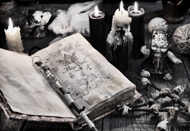 istock Old book with black magic spells, scary doll, black candles and pentagram 919507530