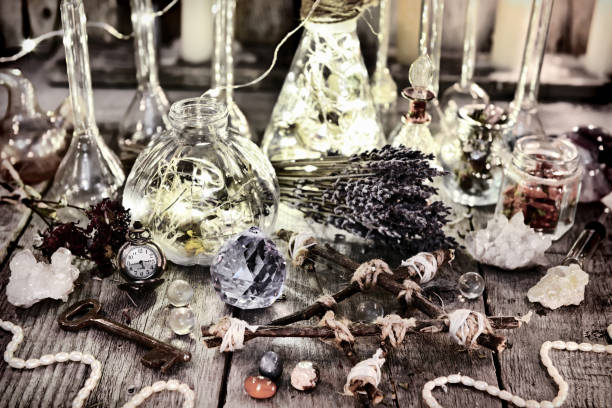 istock Magic bottles with lights, pentagram, crystal, lavender flowers and ritual objects on witch table 919512588