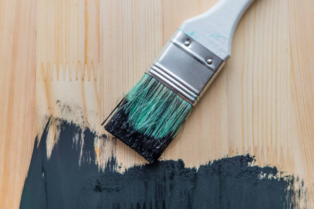 istock black paint on wooden background. selective focus 919520330