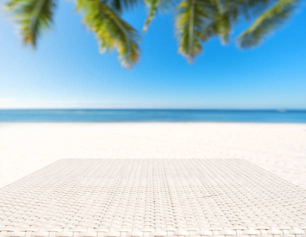istock Wood weave table surface with tropical beach background 919527880