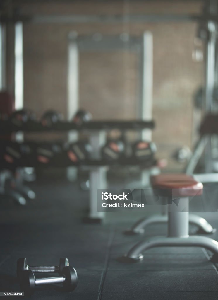 Dumbbells on floor with empty Gym background Gym Stock Photo
