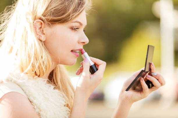 istock Woman applying red lipstick 919530826