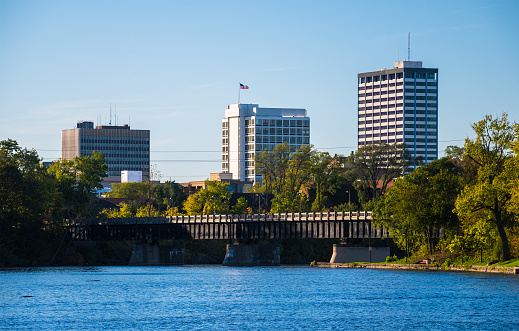 South Bend, Indiana skyline with the Saint Joseph River and a bridge in the foreground.