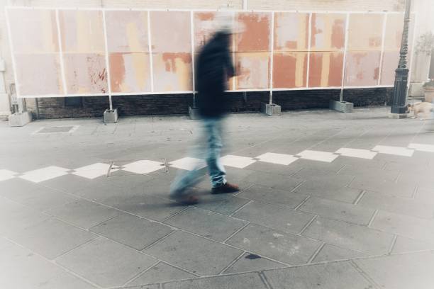 istock isolated blurry person walks in town 919536000
